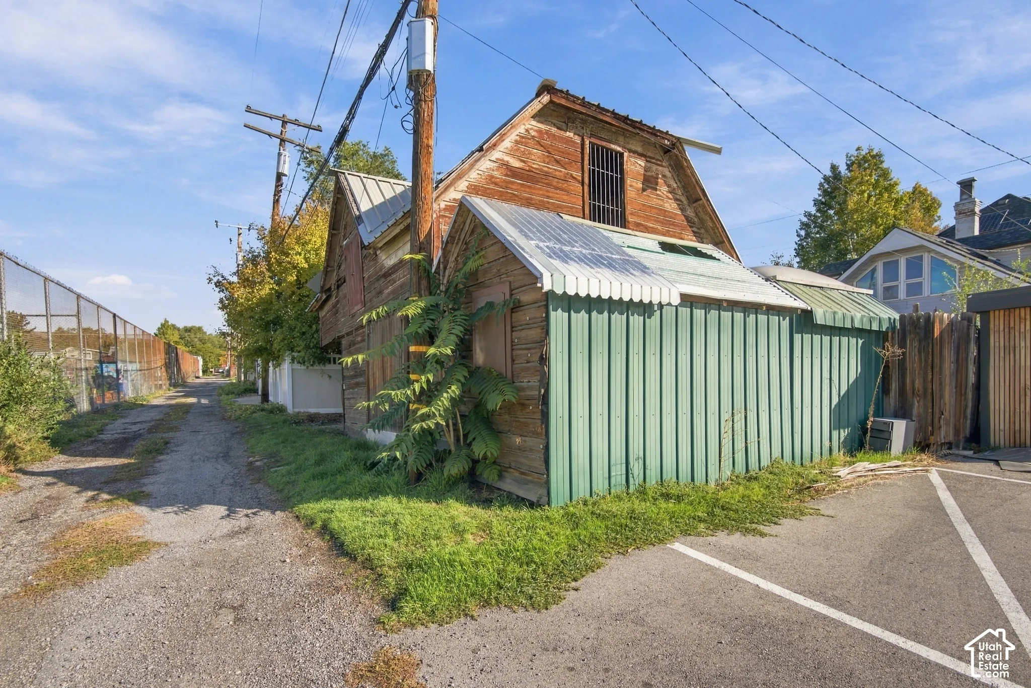 Wood-frame structure with a metal roof and green corrugated metal siding