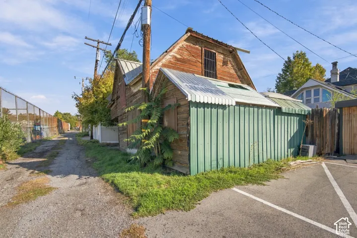 Wood-frame structure with a metal roof and green corrugated metal siding