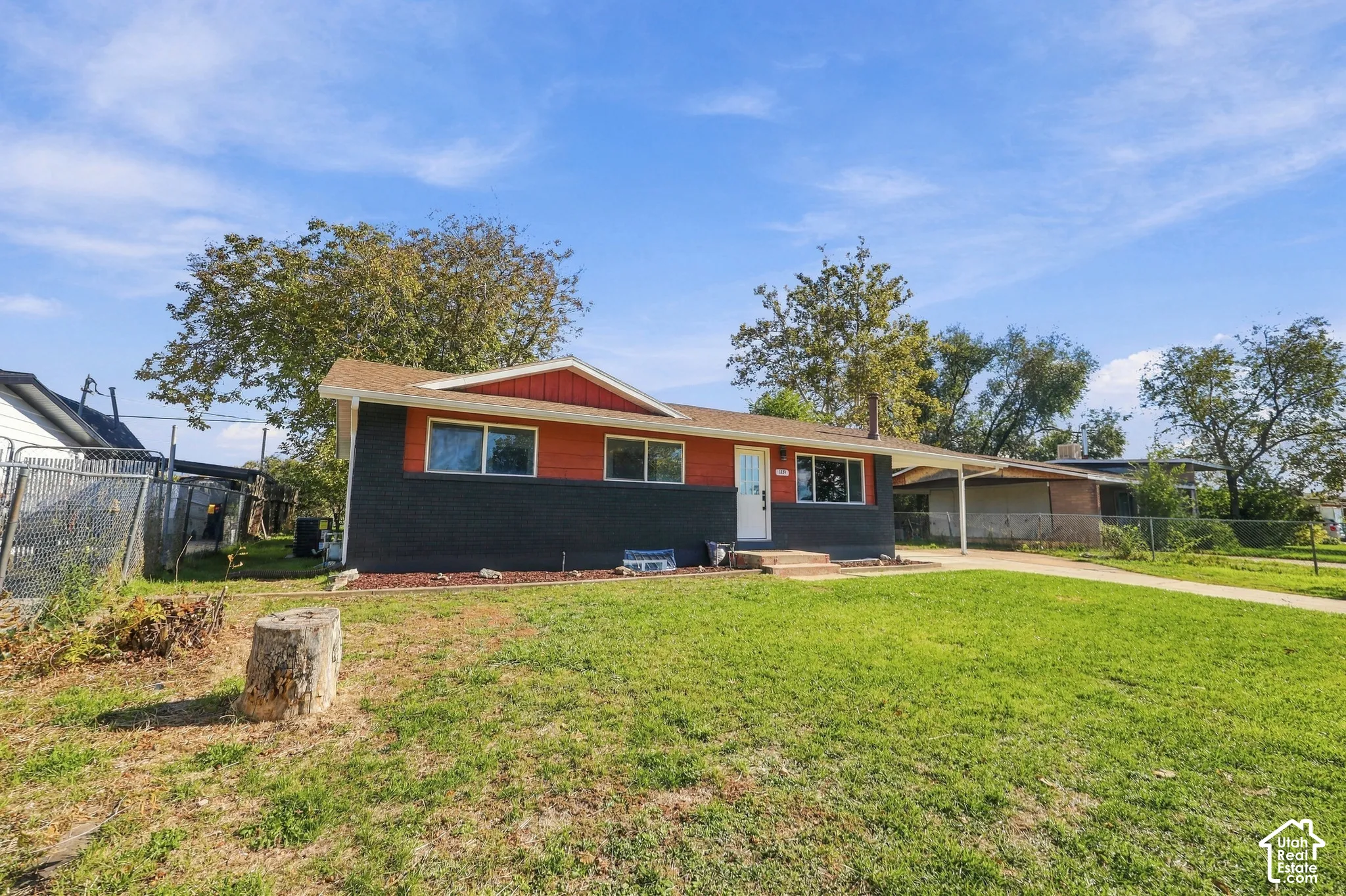 Single-story residence featuring a two-tone exterior, attached carport, and a concrete driveway
