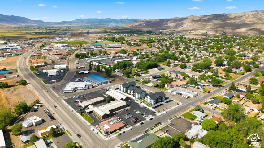 Aerial perspective showcasing the surrounding neighborhood with a mix of commercial and residential properties