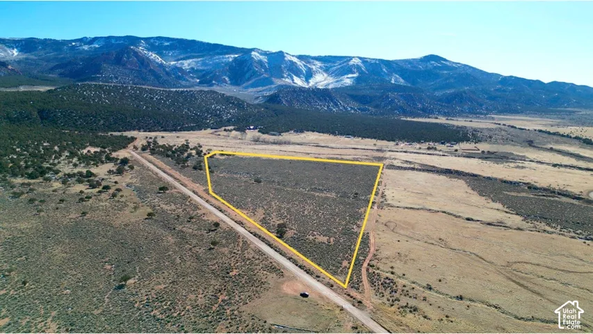 Expansive parcel of land featuring desert vegetation, native terrain, and prominent mountain backdrops