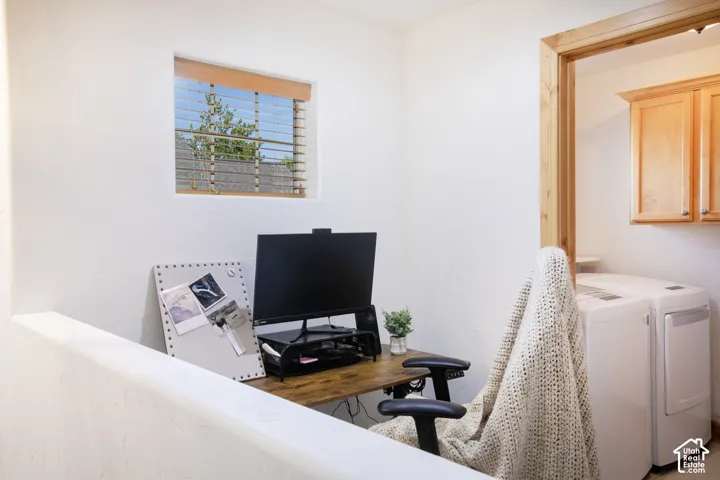 Square-cut window with wood-frame trim, natural wood door casing, and wall-mounted wooden cabinetry