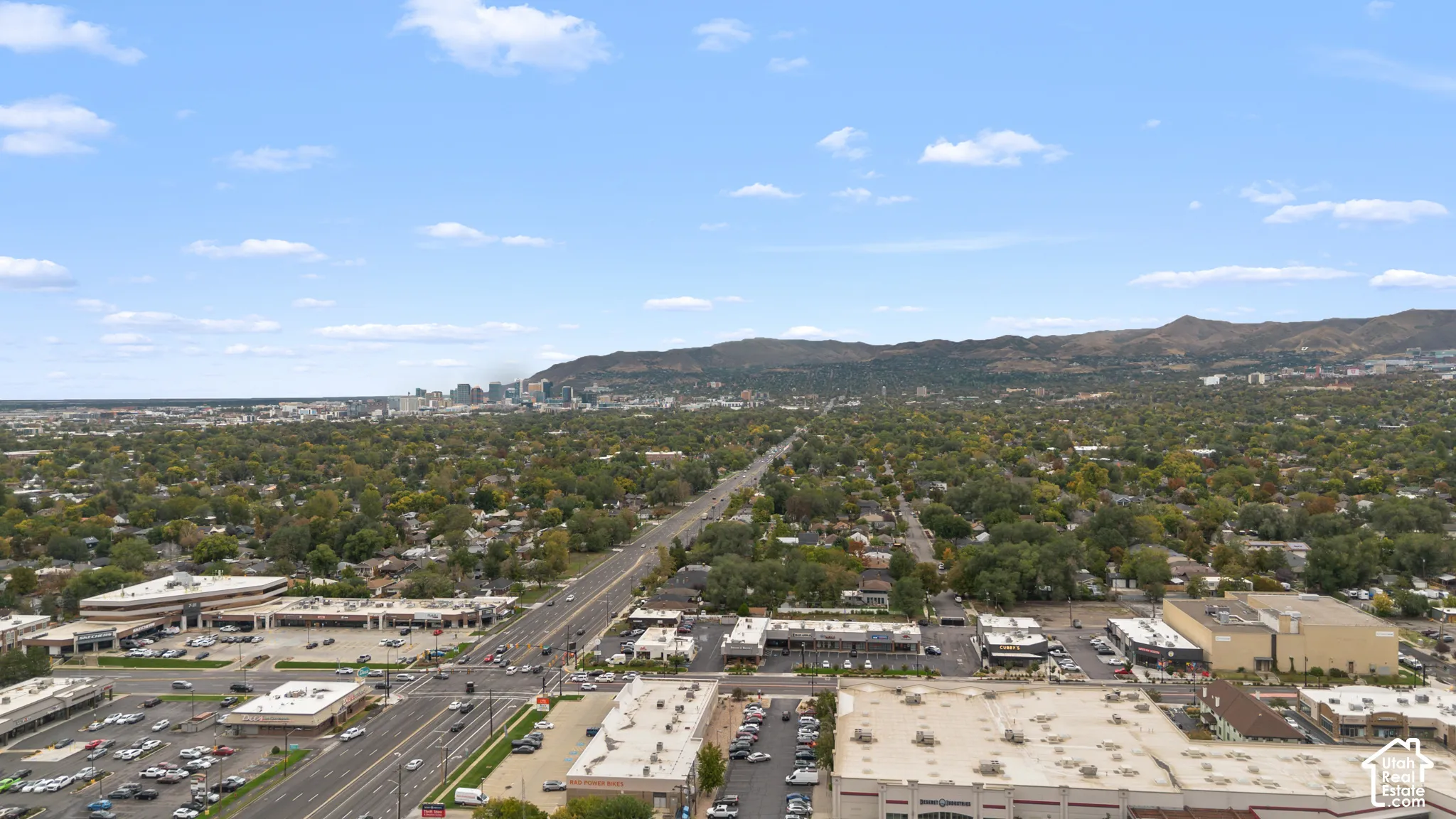 Aerial perspective featuring expansive mountain topography and metropolitan skyline