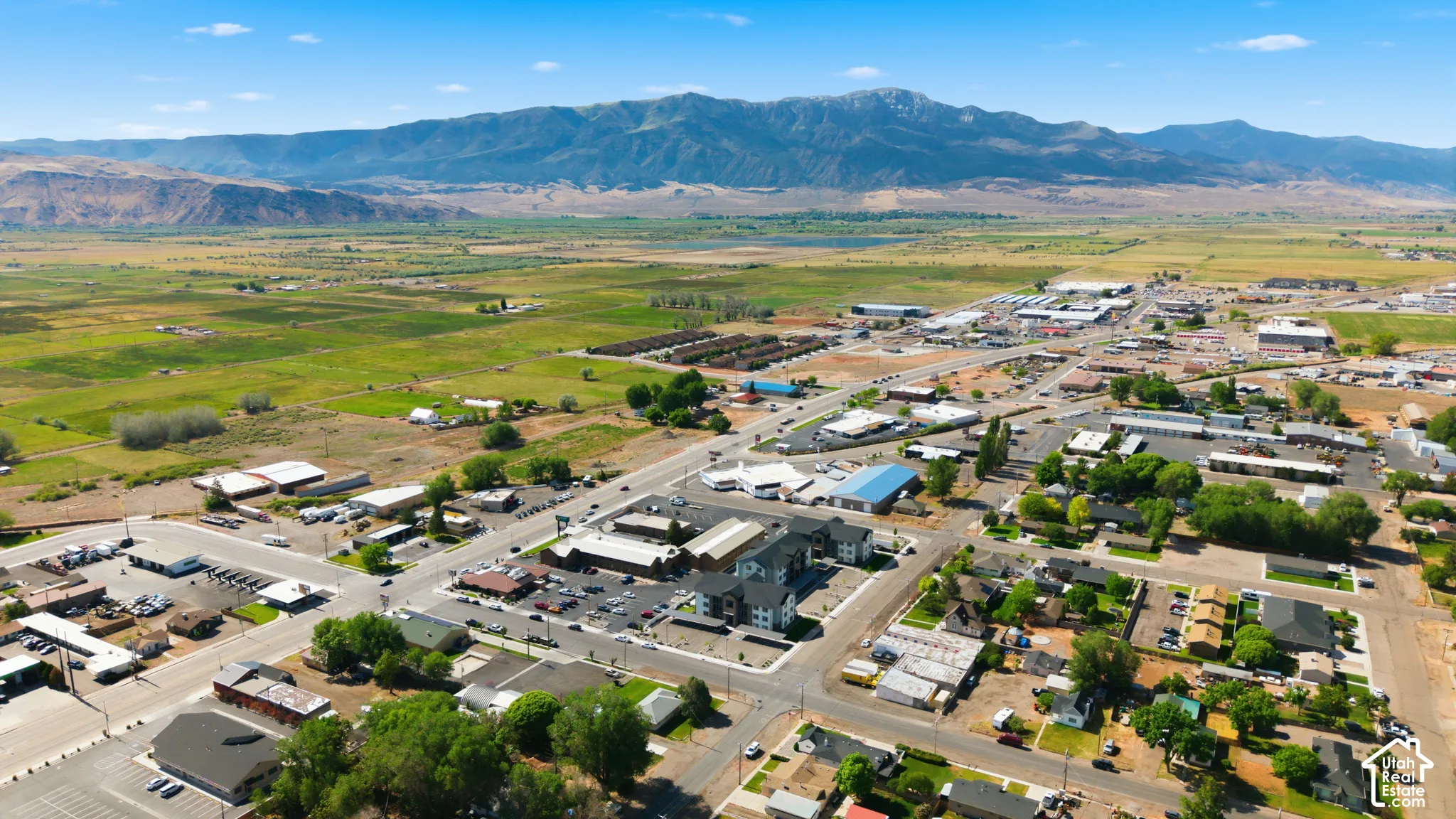 Expansive aerial perspective showcasing a townscape with diverse buildings and surrounding natural landscapes