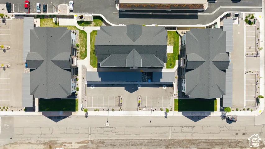 Contemporary multi-building complex featuring dark grey shingle roofs and integrated parking areas