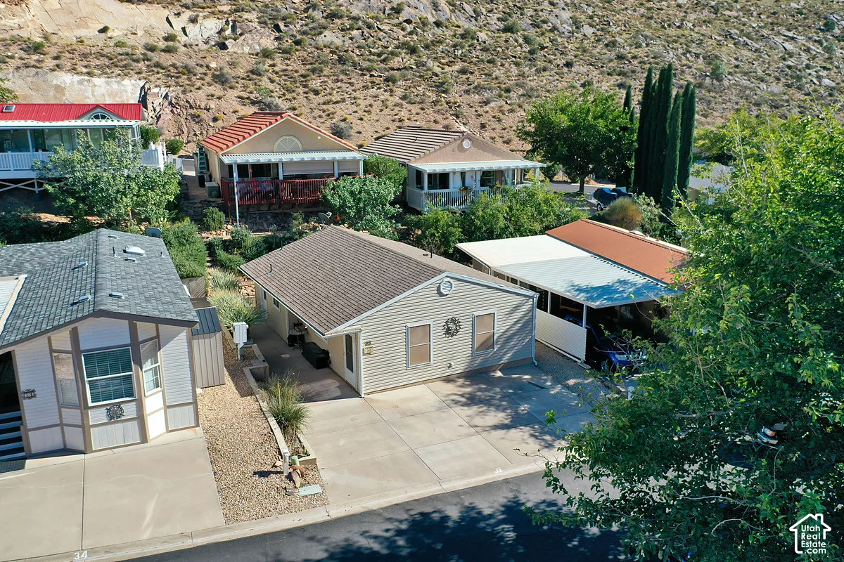Exterior featuring vinyl siding, asphalt shingle roofing, concrete driveway, and attached metal carport