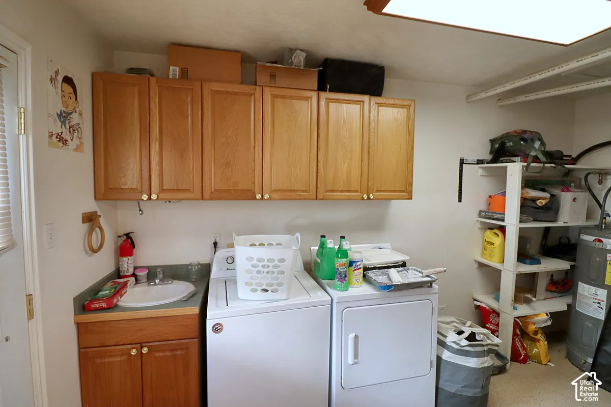 Laundry area featuring wood-finish cabinetry, a utility sink with a solid-surface countertop, and built-in shelving