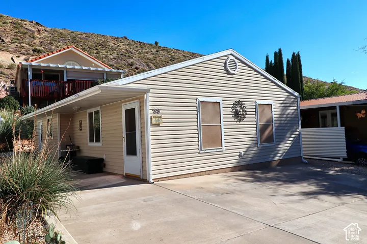 Exterior featuring horizontal siding, a gabled roofline, concrete driveway, and a covered entry