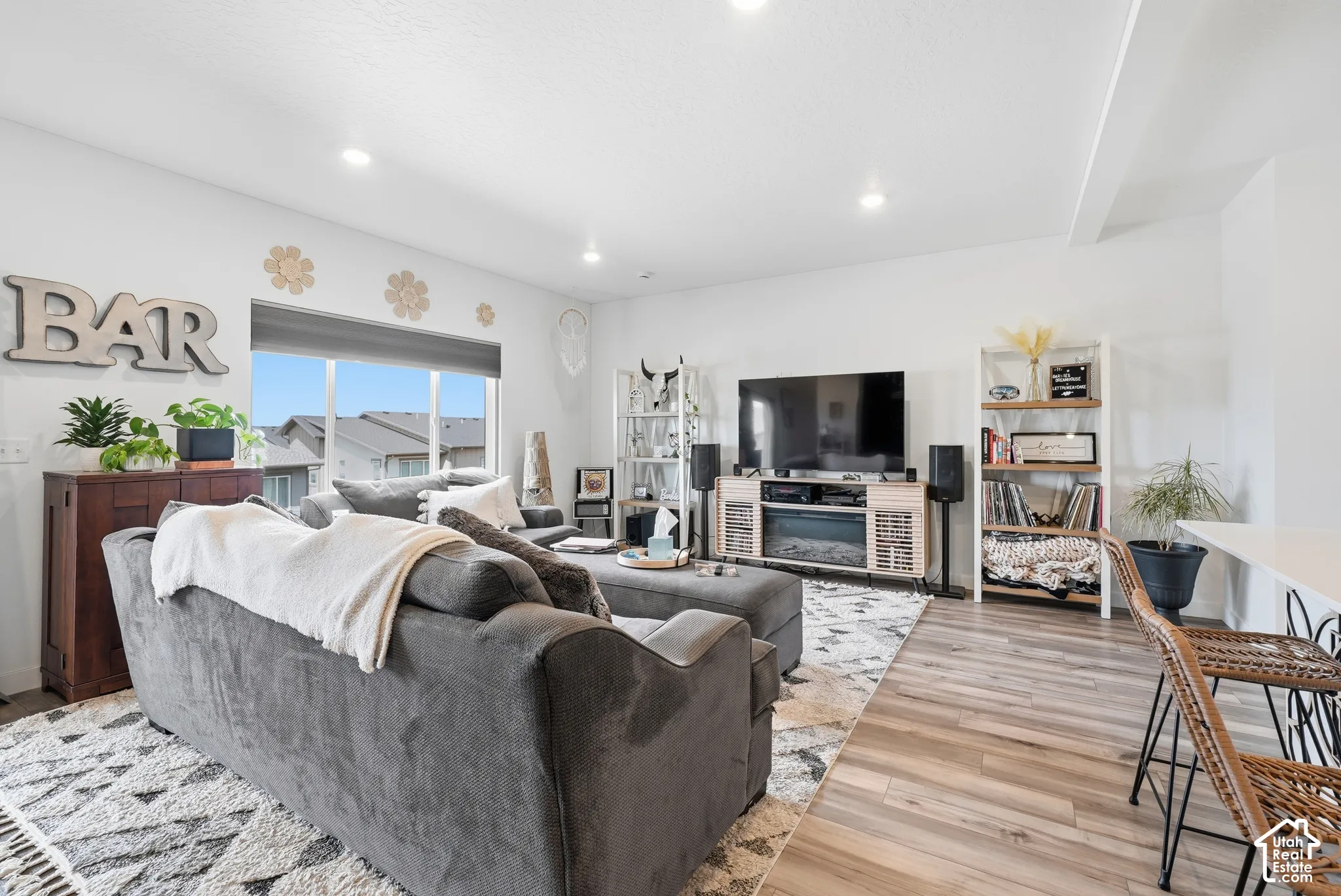 Open-concept interior featuring wood-finish flooring, recessed lighting, and large windows