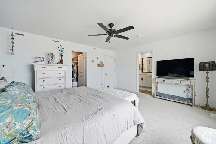 Room featuring neutral wall-to-wall carpeting, a matte black multi-blade ceiling fan, and recessed interior doors