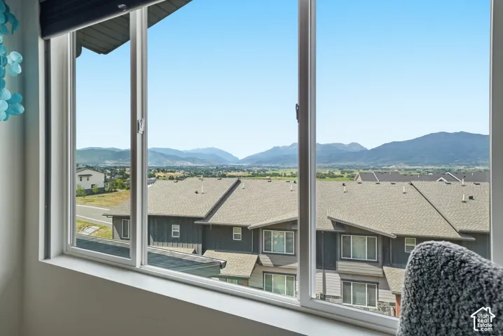 Expansive window featuring a white frame and mountain scenery