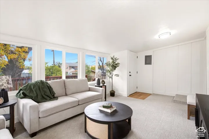 Interior space featuring large windows with natural light, neutral wall-to-wall carpeting, and full-height built-in wall cabinetry