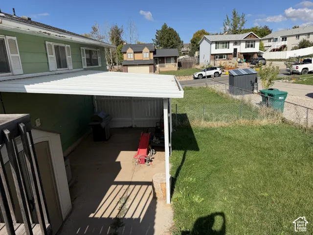 Covered concrete patio, fenced backyard, and exterior siding