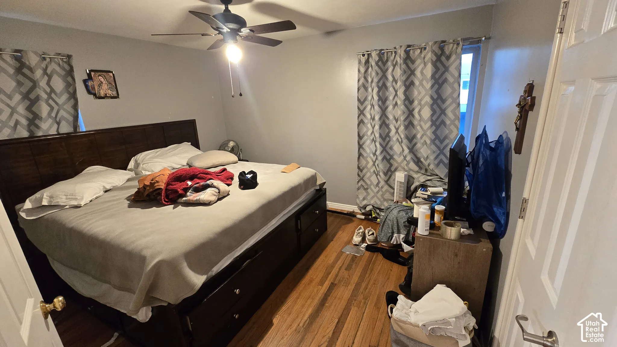Room featuring wood-finish flooring and a ceiling fan with integrated lighting