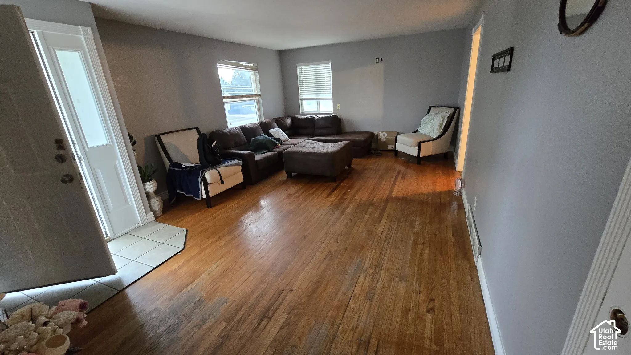 Interior space featuring wood-finish flooring, neutral wall paint, and ceramic tile entry flooring