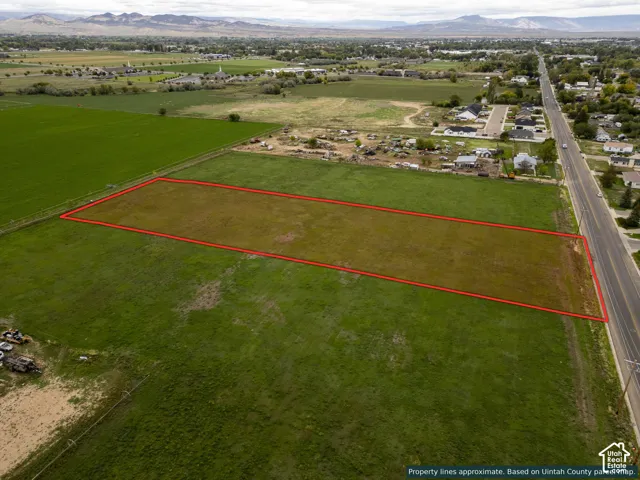 Expansive level lot featuring direct road access and mountain backdrops