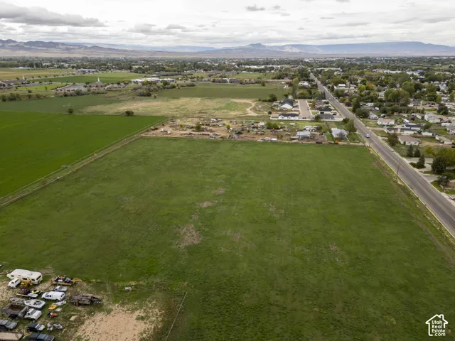 Expansive acreage featuring cleared level terrain and mountain range horizon