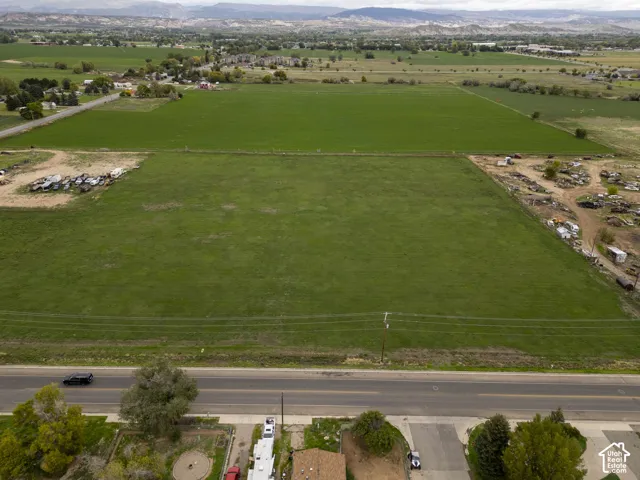 Expansive parcel of land featuring open grass acreage and mountain horizons