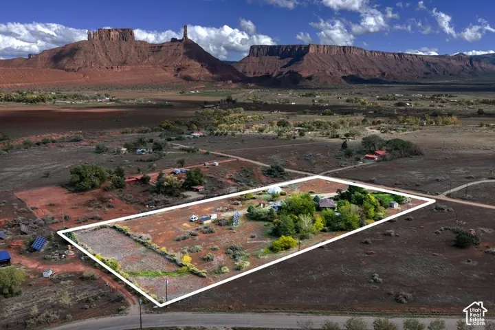 Expansive parcel featuring mature trees, desert landscaping, and prominent red rock mountain scenery