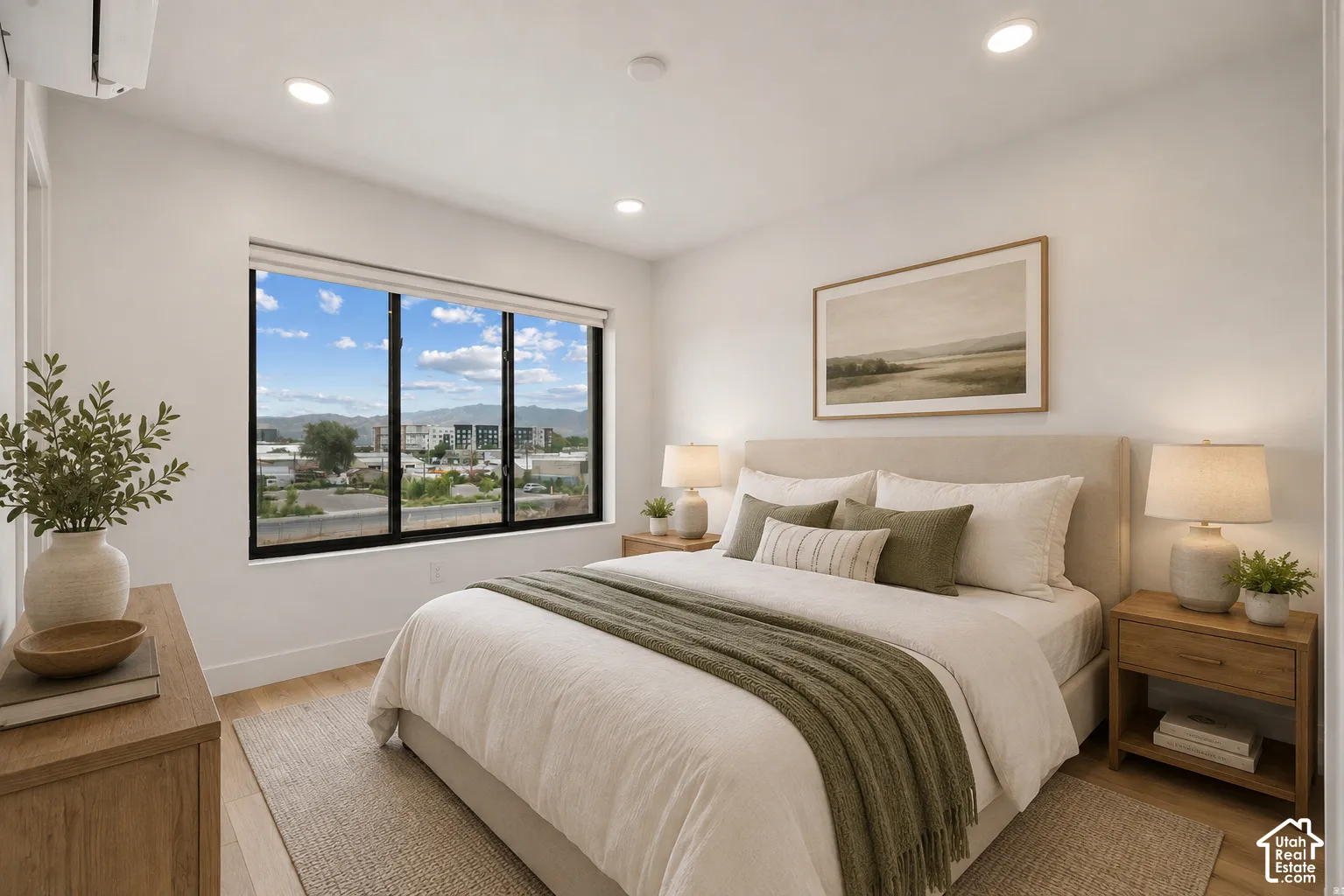 Large black-framed windows, recessed lighting, and wood-finish flooring