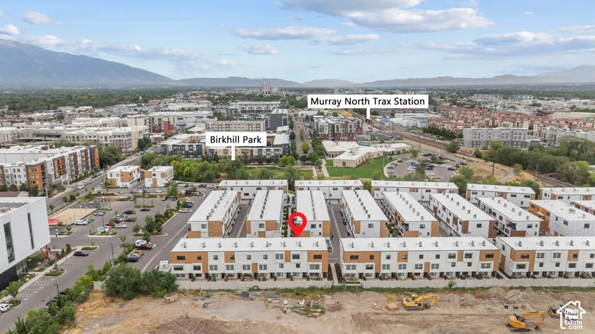 Aerial perspective of multi-story townhome community featuring modern architectural design, flat rooflines, and multi-tone facades