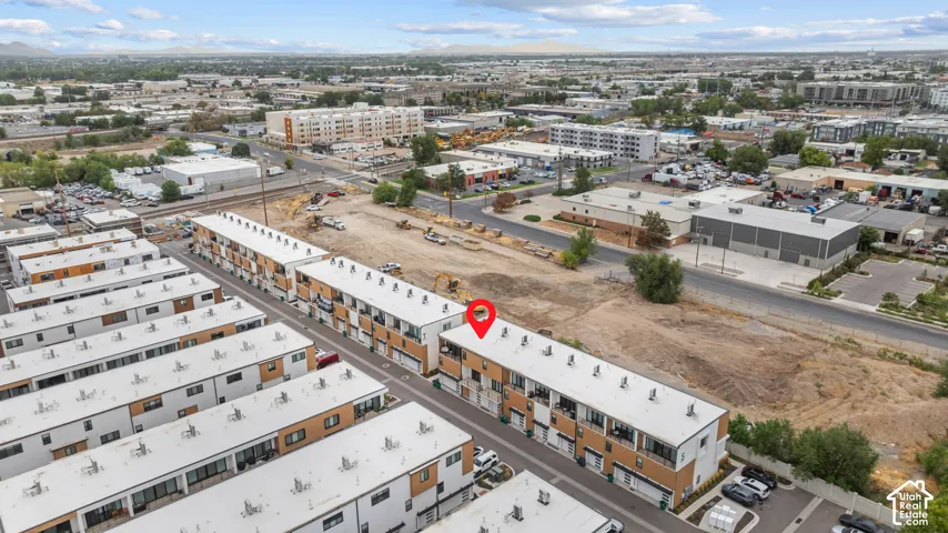 Multi-level townhome featuring a flat roof, integrated garage, and private balconies