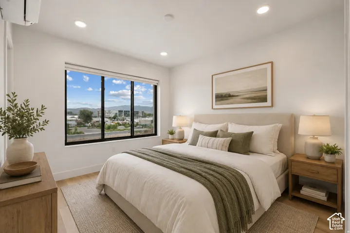 Large black-framed windows, recessed lighting, and wood-finish flooring