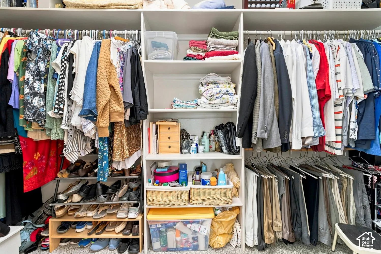 Custom built-in closet organization system featuring adjustable white shelving, dual hanging rods, and integrated shoe storage
