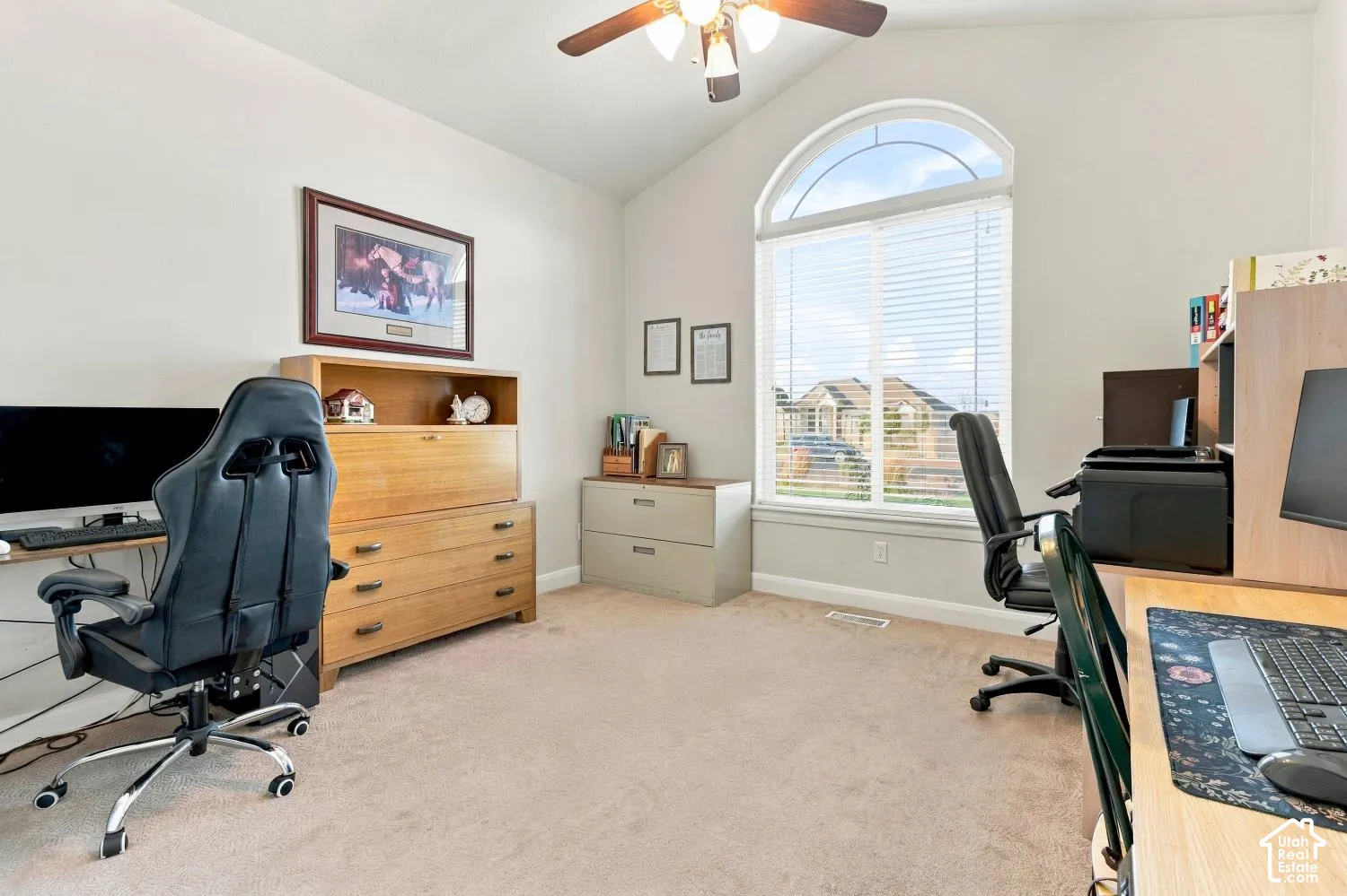 Vaulted ceilings, carpeting, and a large arched window with natural light