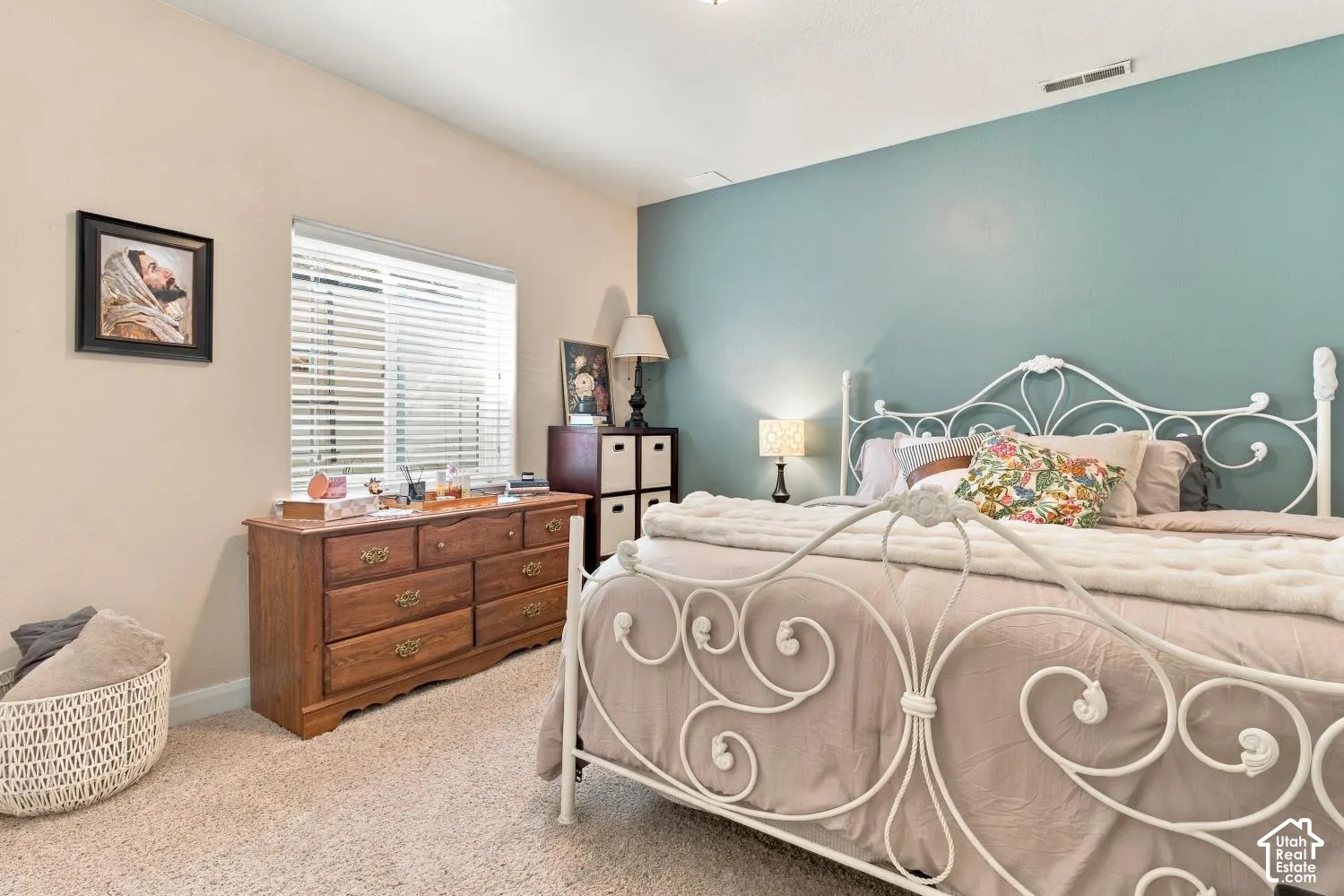 Neutral-toned carpeted flooring, horizontal blinds, and a blue accent wall
