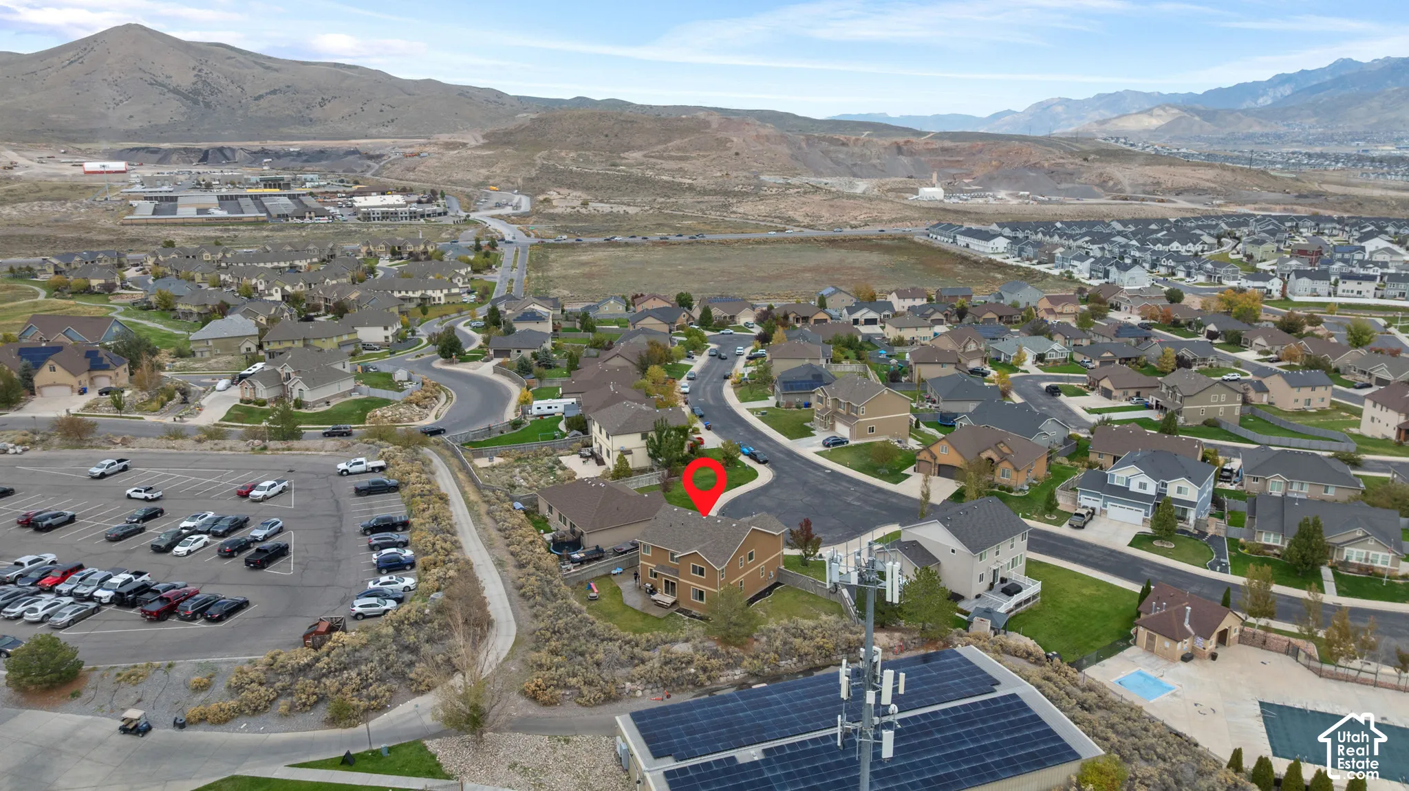 Two-story residential property featuring a pitched roof, exterior siding, and a fenced backyard, situated within a neighborhood setting with mountain backdrops