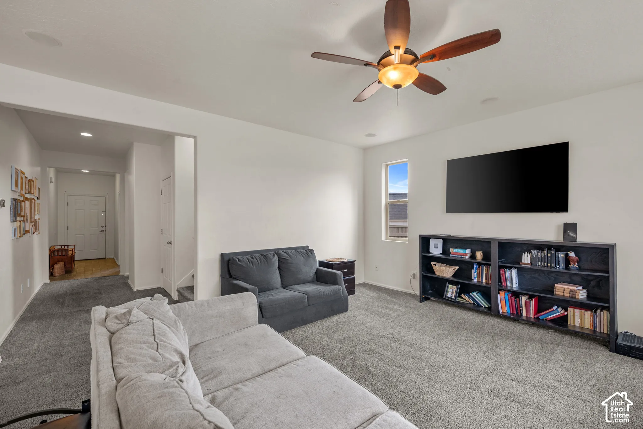 Neutral-toned carpeted flooring, ceiling fan with integrated lighting, and recessed ceiling lights