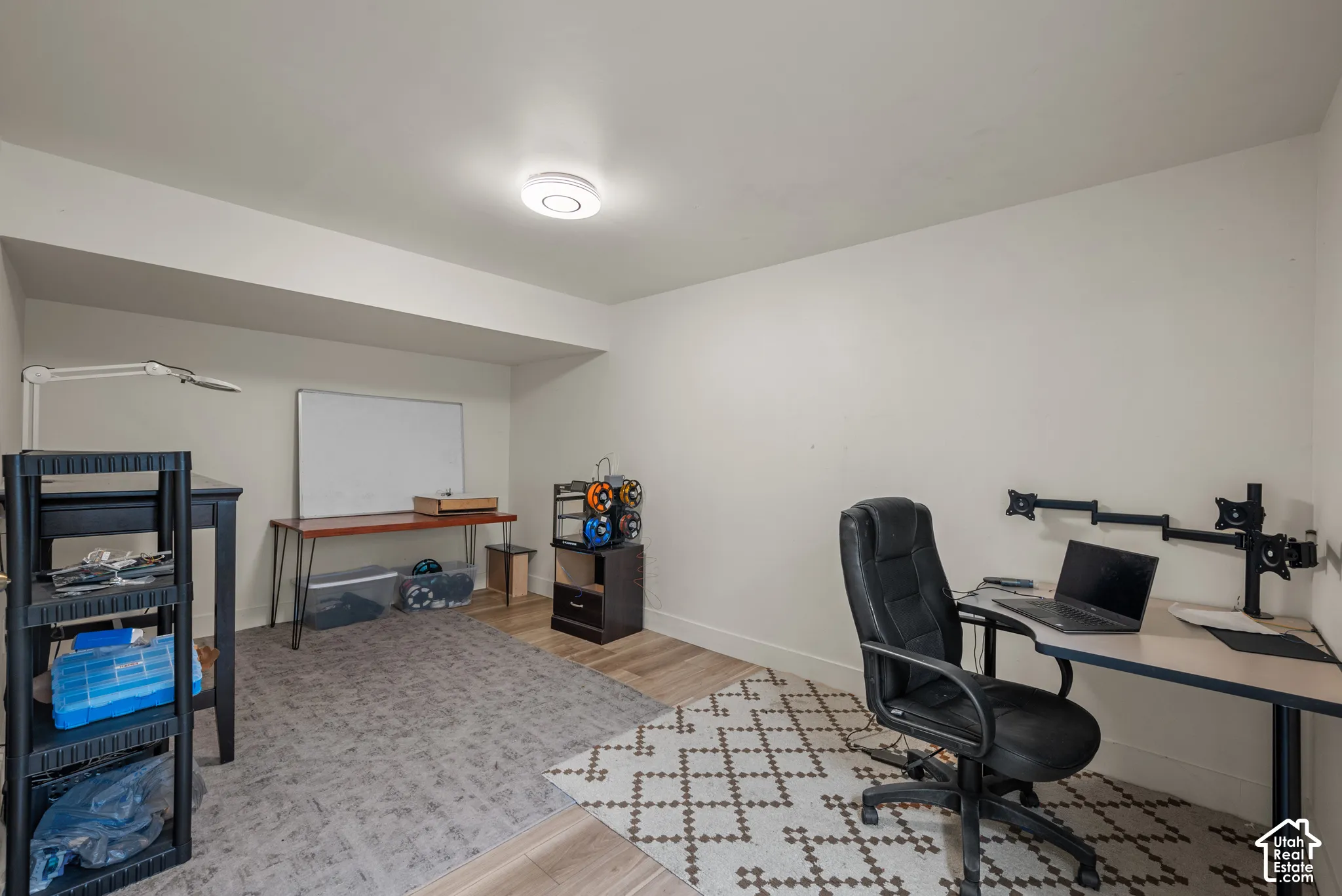 Interior room featuring wood-finish flooring and a ceiling-mounted light fixture
