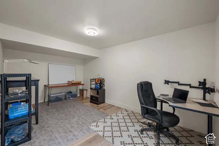 Interior room featuring wood-finish flooring and a ceiling-mounted light fixture