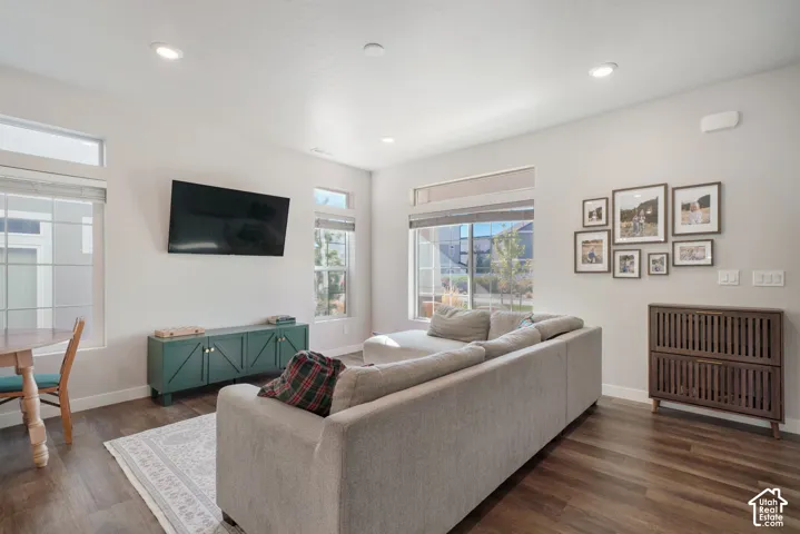 Open-concept space featuring wood-finish flooring, recessed lighting, and expansive windows