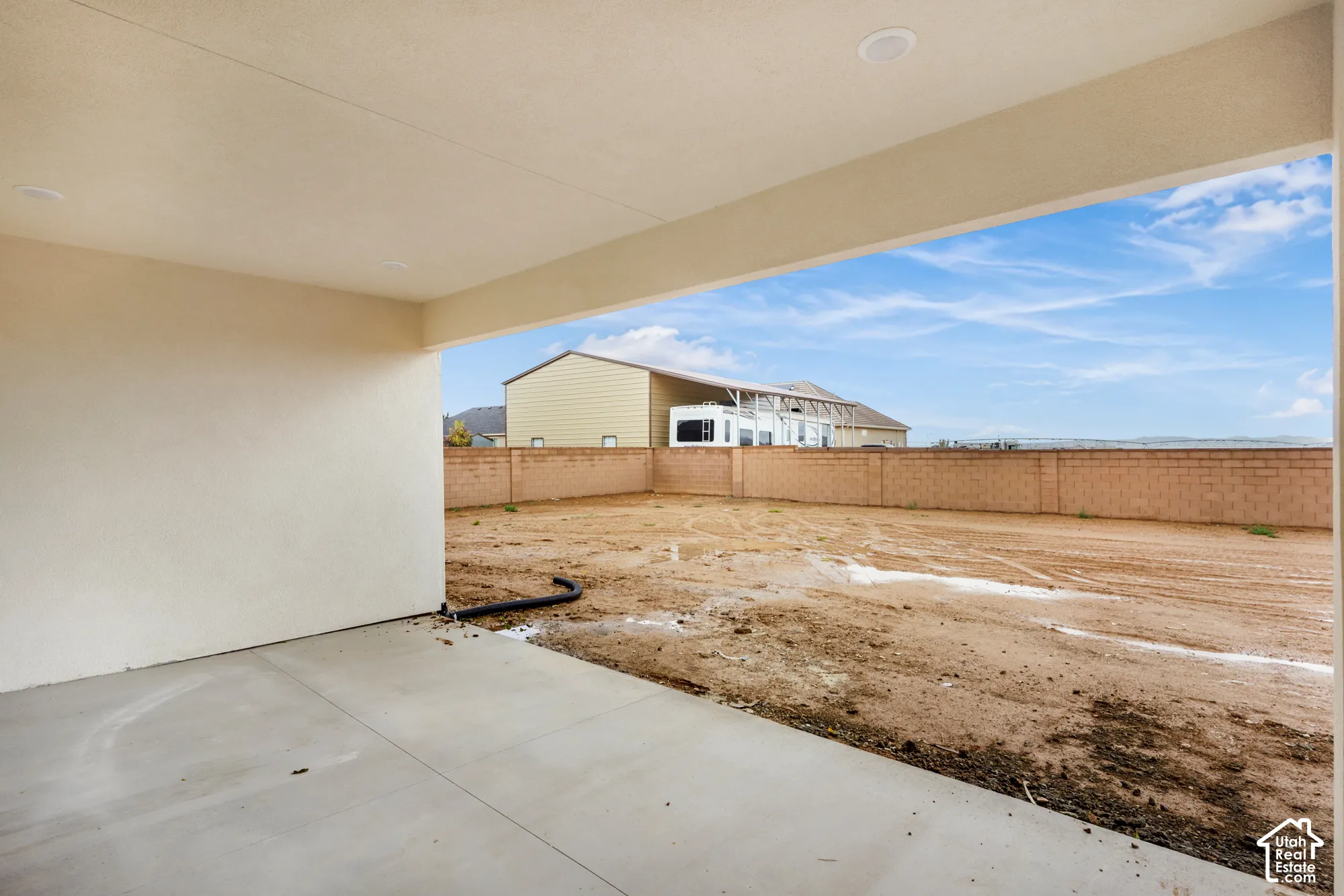 Covered patio featuring a concrete floor, recessed lighting, and a concrete masonry unit perimeter wall