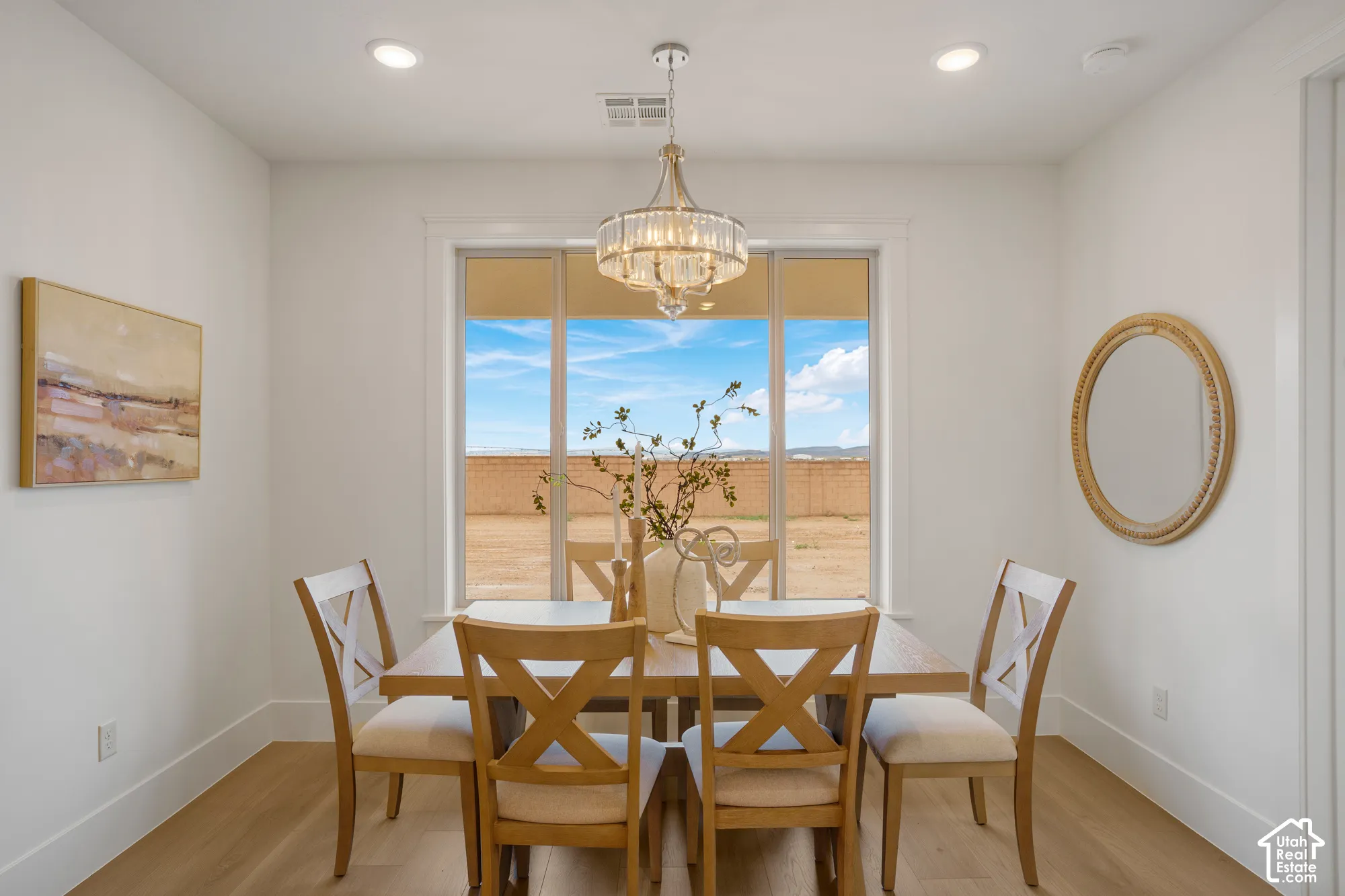 Dining space featuring recessed lighting, a crystal-accented chandelier, wood-finish flooring, and large windows