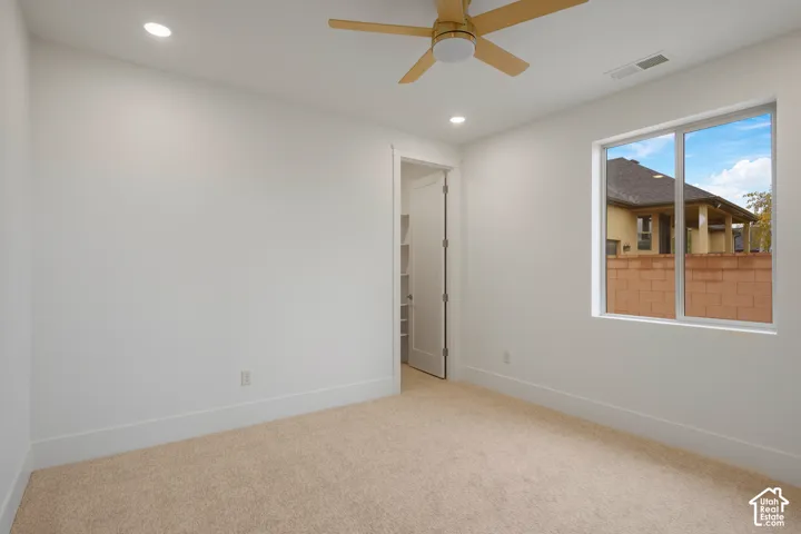 Neutral interior space featuring recessed lighting, a wooden ceiling fan, wall-to-wall carpeting, and a single-pane window