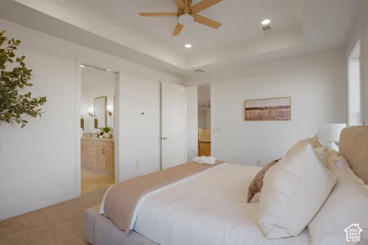 Tray ceiling featuring recessed lighting and a central ceiling fan with wood-finish blades
