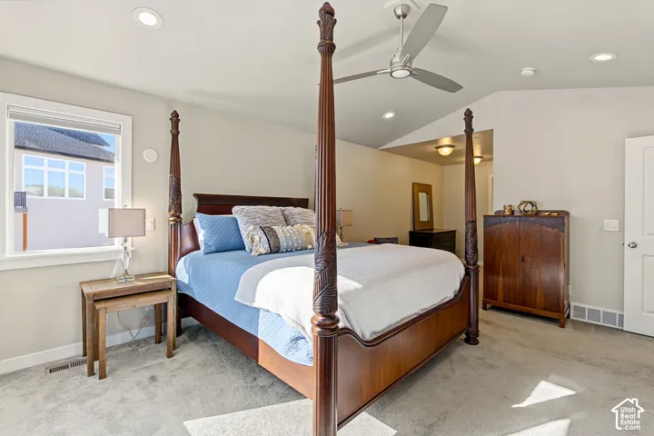 Bedroom featuring a vaulted ceiling, recessed lighting, neutral wall paint, carpeted flooring, and a sleek ceiling fan