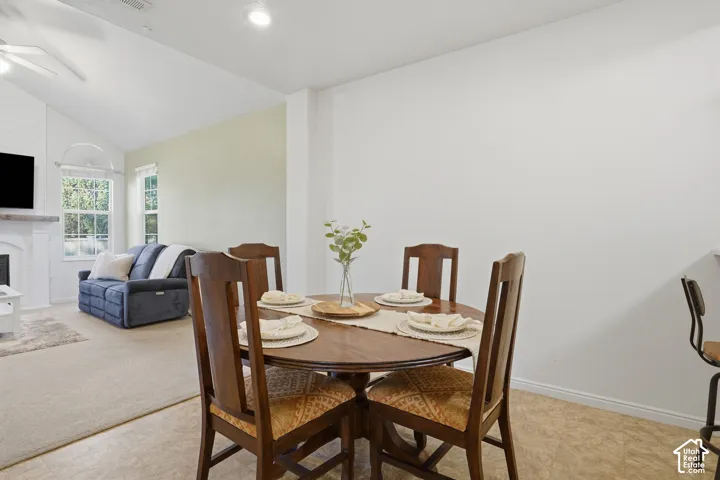 Vaulted ceilings, neutral wall tones, recessed lighting, and tile flooring