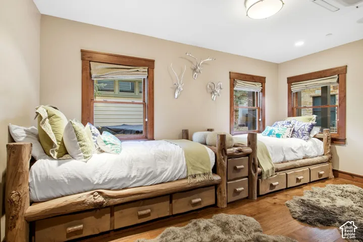 Room featuring wood-finish flooring, natural-finish wood window casings, and flush-mount lighting