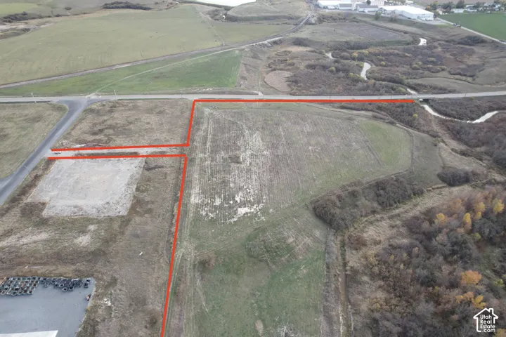 Expansive undeveloped acreage featuring cleared building pad, direct road frontage, and natural topography
