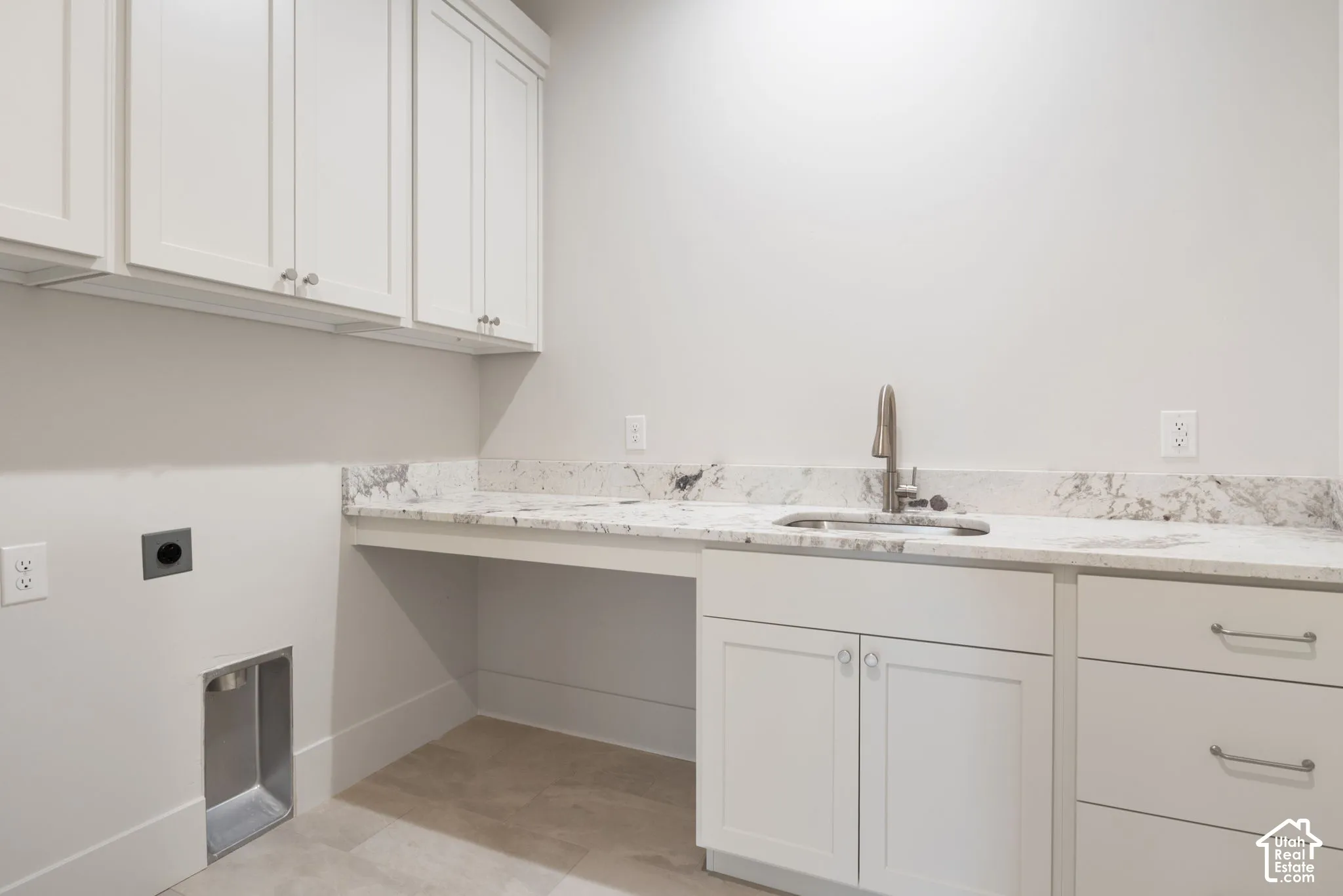 Utility space featuring light-toned shaker cabinetry, stone-finish countertops, an undermount sink with a gooseneck faucet, and tiled flooring