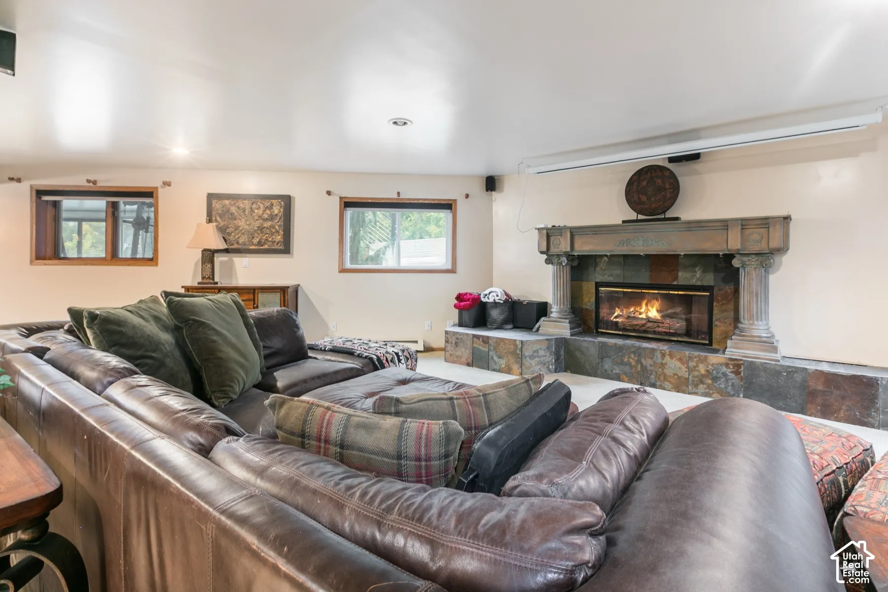 Stone-faced fireplace featuring a detailed mantel, dual columns, and an integrated hearth