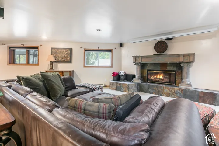 Stone-faced fireplace featuring a detailed mantel, dual columns, and an integrated hearth