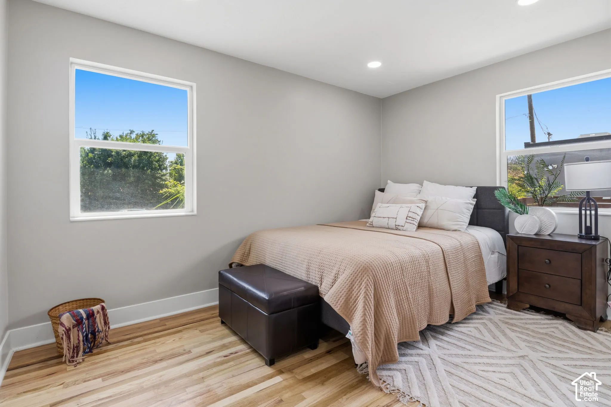 Neutral-toned interior space featuring wood-finish flooring, recessed lighting, and dual-pane windows