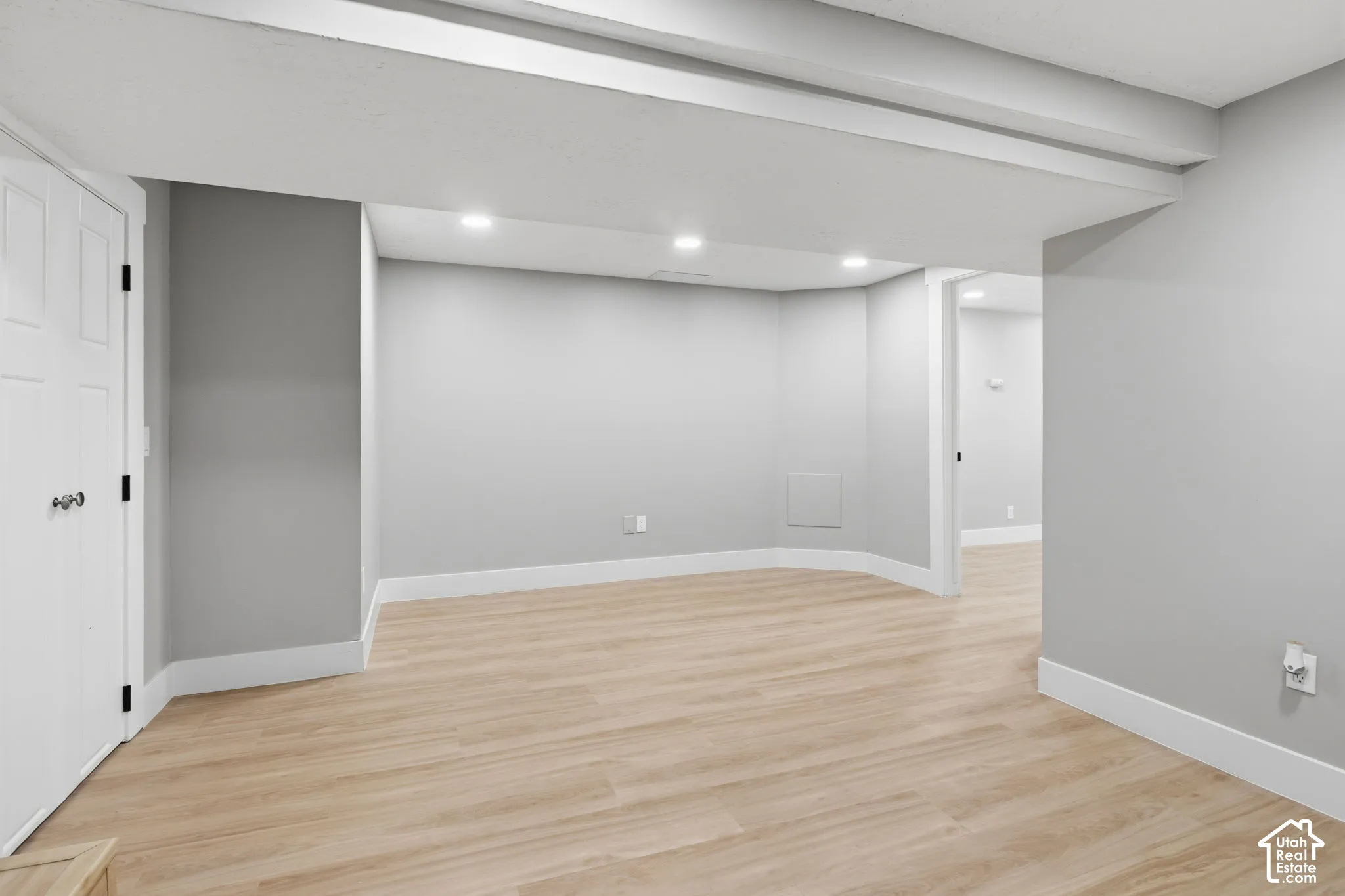 Interior space featuring recessed lighting, wood-finish flooring, neutral wall paint, and a built-in closet with six-panel doors