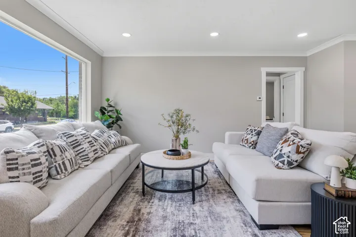 Large picture window, recessed ceiling lighting, and neutral wall color