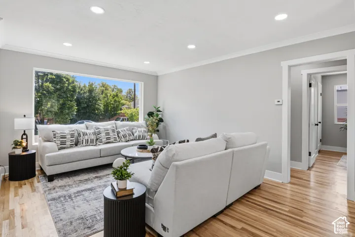 Living area featuring wood-finish flooring, recessed lighting, and a large picture window